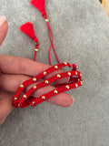 Trío de pulseras rojas